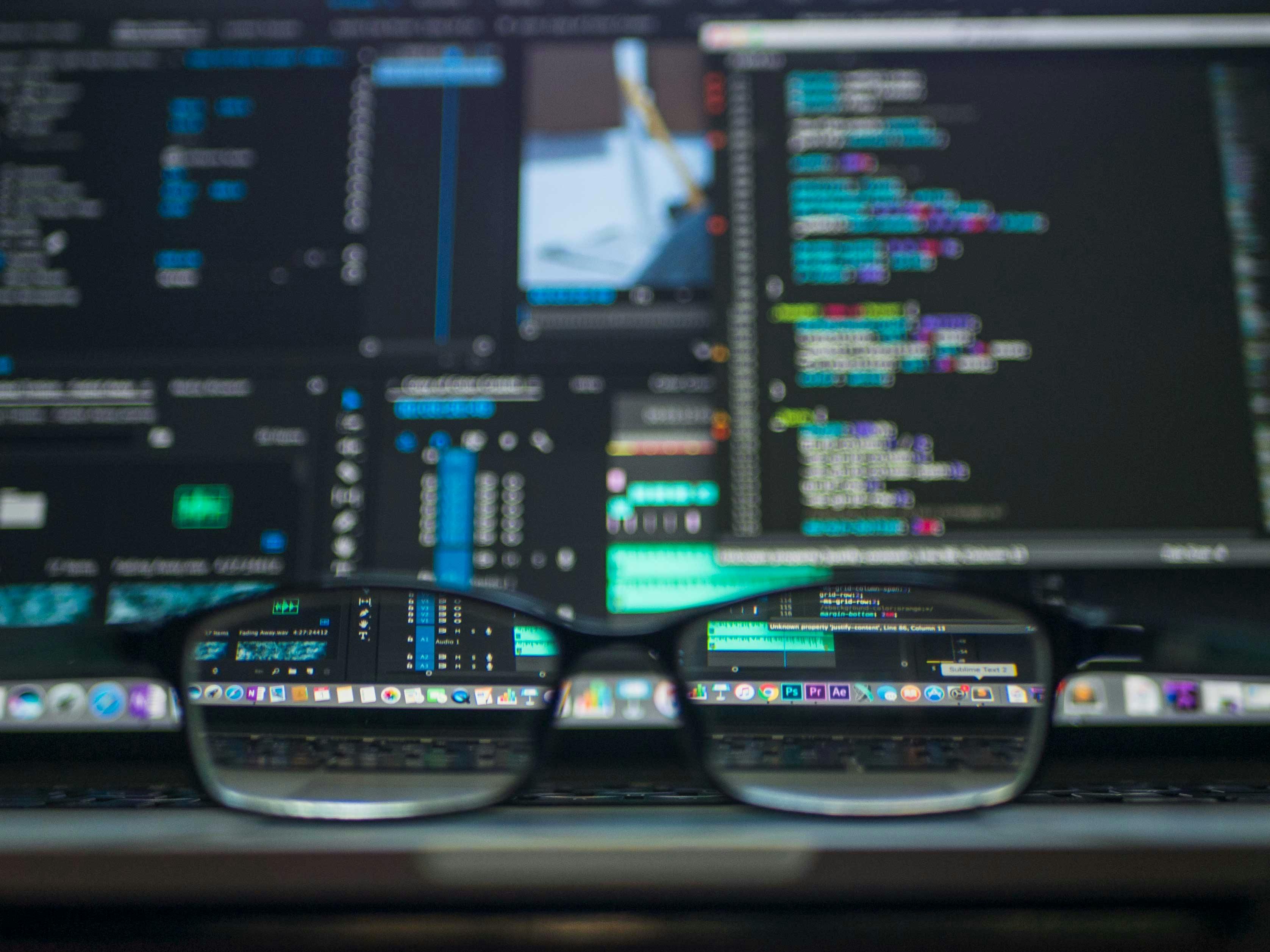 Professional wearing glasses working on cybersecurity tasks